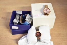 A group of four fashion watches, comprising a boxed rose gold Michael Kors wristwatch having a