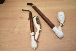 Two presumed 20th-century Austrian or German 'Gesteckpfeife' porcelain pipes, featuring hand painted