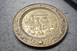 Two large decorative 20th-century brass decorative wall-hanging chargers, featuring two different