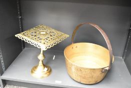 A Victorian brass trivet, featuring an intricate openwork square top plate, mounted upon a