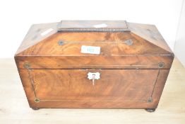 A 19th-century Georgian-style mahogany tea caddy, of sarcophagus-form with a raised lid, having