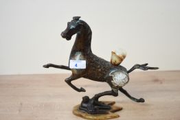 A 20th-century Chinese bronze Flying Horse of Gansu-style sculpture, featuring decorative inlaid