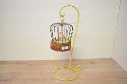An early to mid 20th-century bird in a cage automaton, featuring a windup mechanism that upon