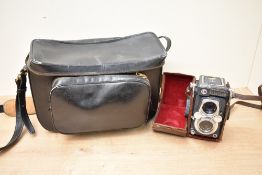 A Yashicka 44 reflex camera with Yashinon 1:3,5 60mm lenses in leather cover