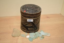 A 20th-century Chinese hand carved wooden box, of cylindrical form, featuring a large dragon-like