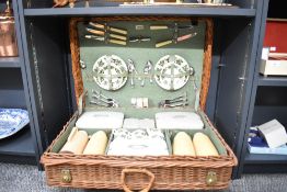 A large mid 20th-century Sirram picnic set, featuring a hinged-lid wicker case that include