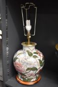 A late 20th-century floral ceramic lamp base, of baluster form, featuring a hand-painted peony-style