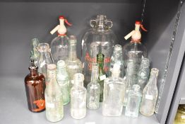 A selection of late 19th to 20th-century glass bottles, to feature a Boots The Chemist medicinal