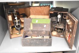 Three presumed 19th-century to early 20th-century cased microscopes, having a selection of related