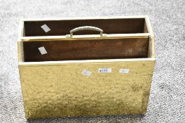 A mid 20th-century hand beaten brass free standing Canterbury, having repetitive circular