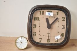 A mid to late 20th-century Hanson wall clock, having a square brown plastic case with rounded edges;
