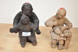 Two 20th-century Chinese hand-formed terracotta sculptures depicting mothers with children, both