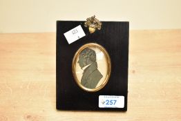 A 19th-century silhouette portrait miniature of a gentleman, featuring a gilt-brass mount set within