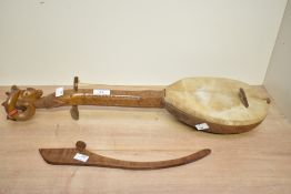 Thought to be 20th-century Balkan gusle-style wooden musical instrument, having a single string