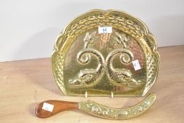 A late 19th-century Art Nouveau-style brass crumb tray and brush, featuring an embossed design of