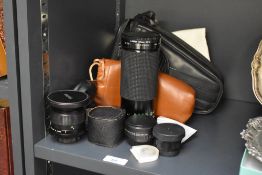 A camera case with a Mikinon 1:4-5,6 35-300mm lens, a Vivitar 28mm 1:2,5 Auto Wide angle lens, a