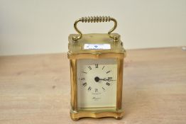 A small late 20th-century Rapport London solid brass carriage clock, featuring a classic quartz