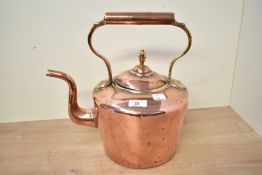 A large late 19th to early 20th-century copper fireside kettle, featuring an acorn-shaped finial,