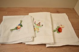 Assorted Portugese white cottons, hand embroidered with charming motifs to include apples, pears,