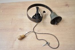 A early to mid 20th-century metal shop doorbell, unmarked, approximately 18cm from base of bell to