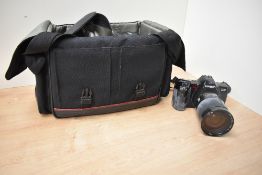 A Minolta Dynax 7000i SLR camera with Minolta AF Zoom 28-135mm 1:4-4,5 lens, Vivitar 100-300mm 1:5,