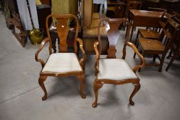A pair of early 20th Century walnut carver chairs having vase backs and Queen Anne style legs