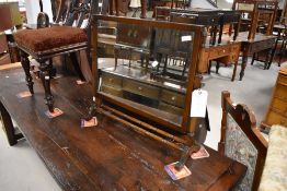 An 20th century mahogany swing dressing mirror, the rectangular plate pivoted between and over