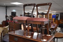A pair of Victorian mahogany balloon back dining chairs, with moulded rails and serpentine fronted