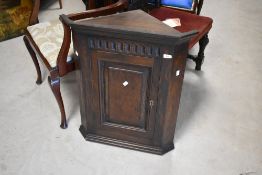 A traditional dark oak corner cupboard , height approx. 74cm