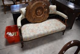 A Victorian mahogany framed salon settee having bobbin turned spindle back and later upholstery,