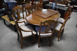 A modern extending dining table and set of eight (six plus two) dining chairs, labelled Homestead (