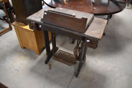 A vintage Singer sewing machine and table (af)