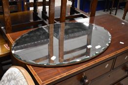A vintage frameless wall mirror of oval form, approx. 76 x 50cm