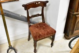 A pair of Victorian mahogany dining chairs, having concave scroll end top rails over scrolled mid