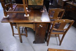 An early to mid 20th Century oak gate leg dining table and set of four similar dining chairs
