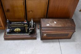 A vintage hand cranked sewing machine , by Singer, registration number V974899, with integral case