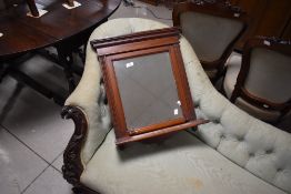 A Victorian style mahogany wall mirror with shelf , also includes separate rail attachment