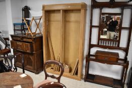 A traditional pine double bookshelf, some of the moulding missing from the top is present,