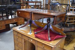 A pair of reproduction Regency style occasional table having drop leaf tops on turned column and