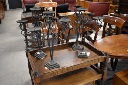 A set of four wrought iron candle stands