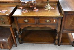 A nice quality reproduction oak side table, most probably Titchmarsh and Goodwin, having two drawers