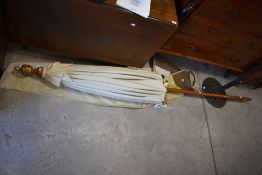 An Oriental style parasol and a cast metal base