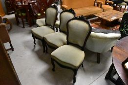 A group of four French Louis XV style dining chairs, having foliate carved crest rails over the