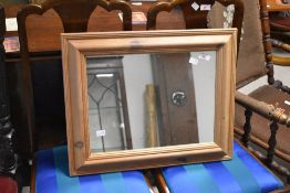 A small decorative pine framed mirror 43cm x 53cm