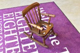 A 19th Century child's commode style rocking chair, width approx. 35cm, some signs of historical