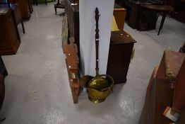 A traditional brass warming pan and coal helmet