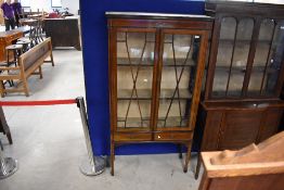 An Edwardian mahogany and line inlay display cabinet having glazed section over two short drawers,