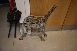 A pair of cast metal bench ends