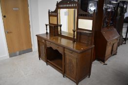 A late Victorian oak mirror back sideboard, of typical arrangement with three bevelled glass
