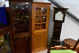 A vintage pine corner display cabinet with cupboard to base